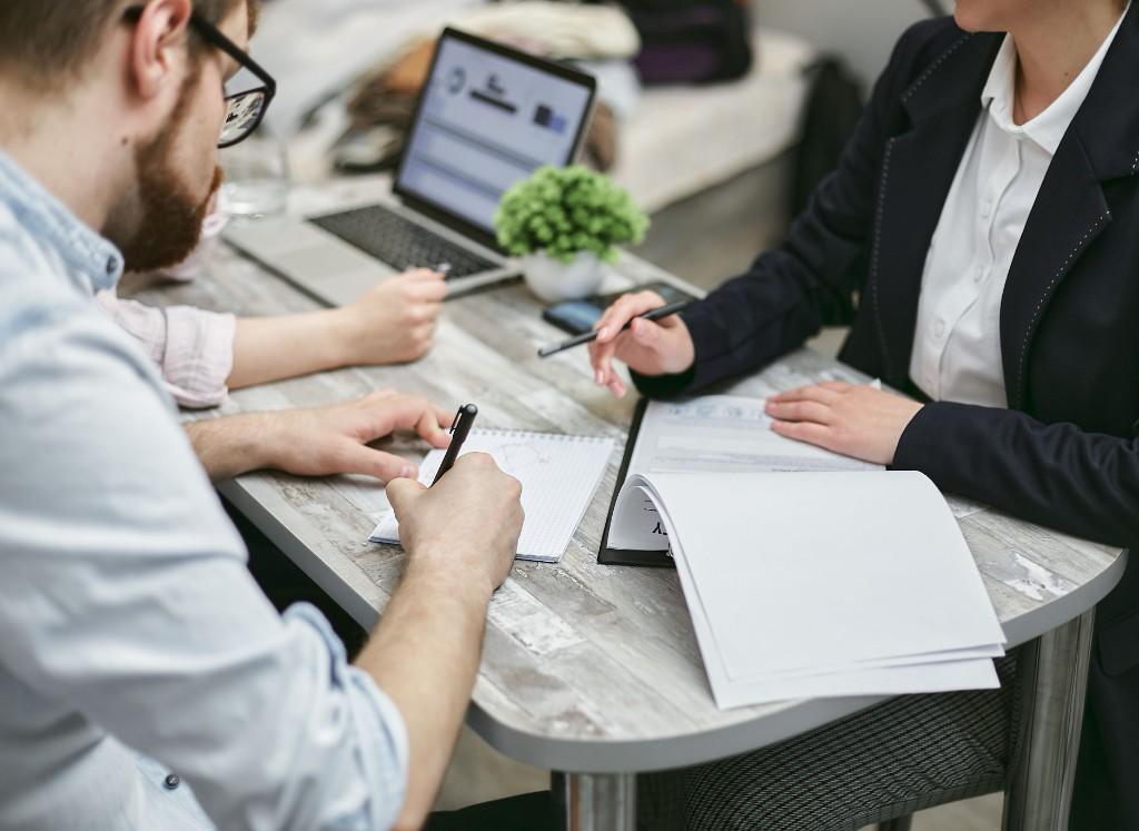 Practitioners reviewing documents and case materials around a table